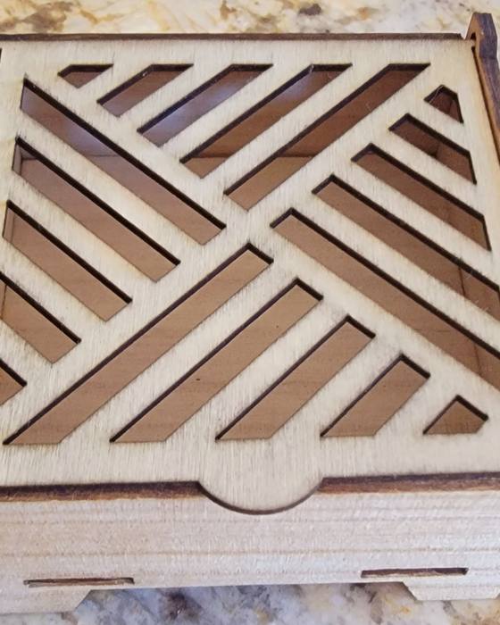 A laser-cut wooden box with a geometric lattice lid