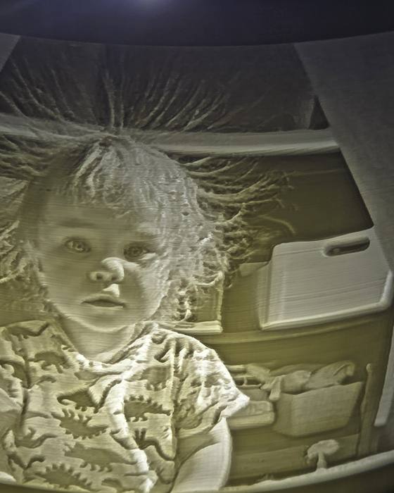 A 3D-printed lithophane portrait lit from behind