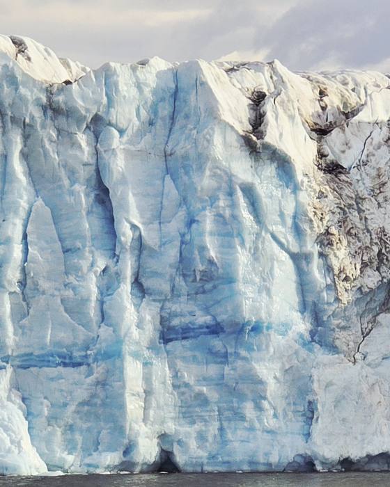 A glacier face calving into the sea, Arctic